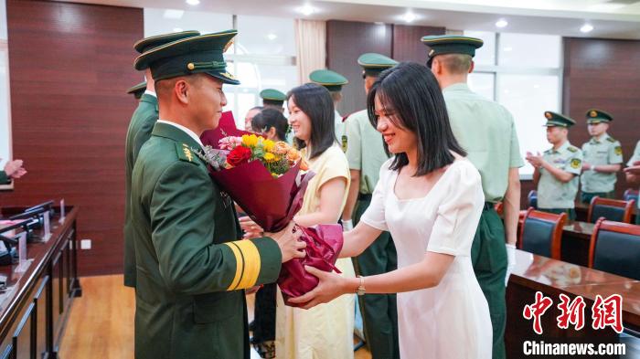 軍屬向晉升警官獻(xiàn)花。　張煜梁 攝