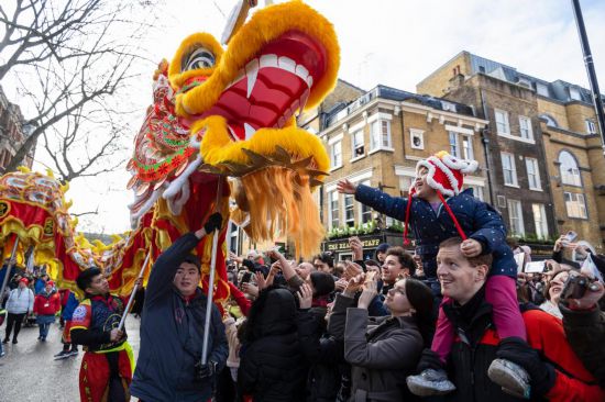 2月11日，人們在英國倫敦的新春巡游活動中觀看舞龍表演。新華社發(fā)（史蒂芬·程攝）
