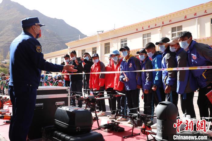 圖為消防指戰(zhàn)員為學(xué)生講解、演示先進(jìn)救援裝備?！≮w琳 攝