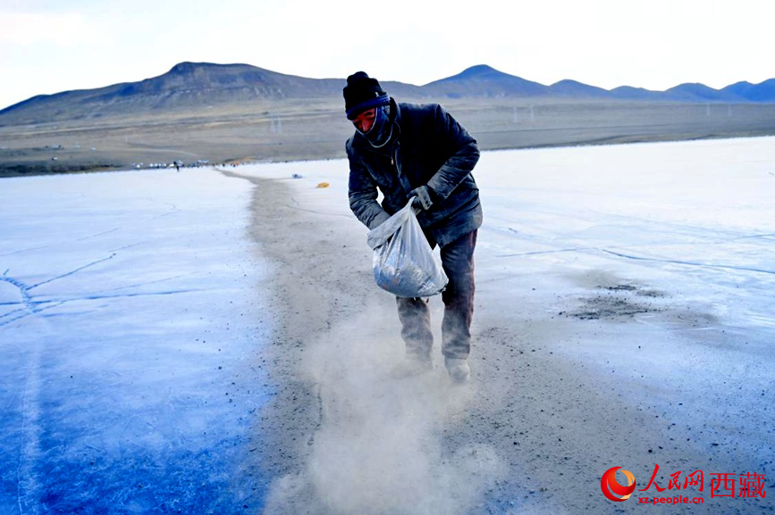 牧民在冰面上撒灰鋪成通道。人民網(wǎng) 李海霞攝